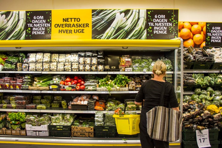 A customer browses a cabinet of fresh vegetables for sale inside a Netto discount store, operated by Danske Supermarked A/S, in Copenhagen, Denmark, on Friday, June 27, 2014. 