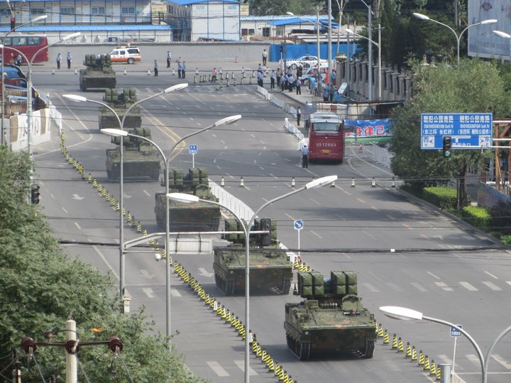 Tanks and armored vehicles roll through eastern Beijing on a practice run for the parade.