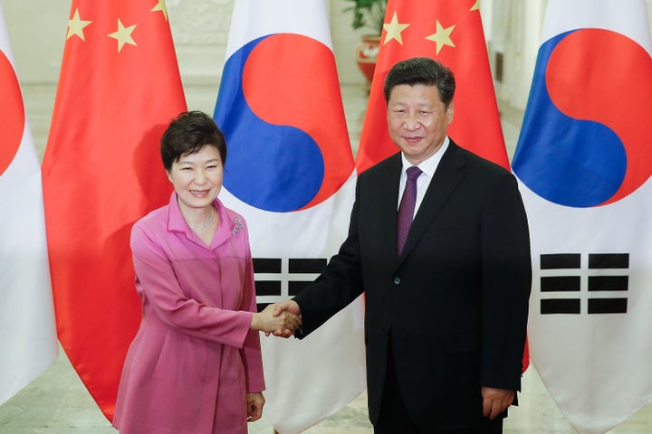 Chinese President Xi Jinping (right) shakes hands with South Korean President Park Geun-hye (left) at The Great Hall Of The P