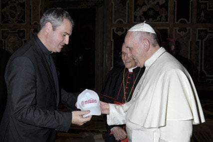 The Rev. Andrew Small, national director of the Pontifical Mission Societies in the United States, left, greets Pope Francis.