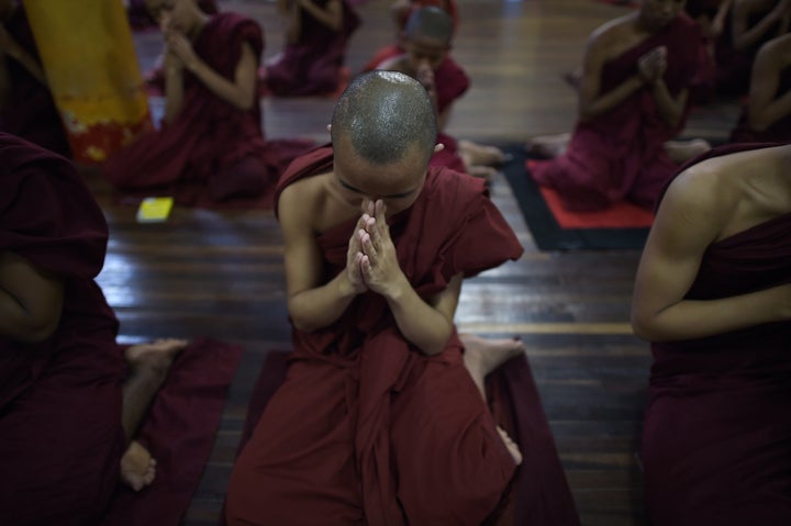 <p>This picture taken on June 24, 2015 shows Buddhist novices praying at a monastery affiliated with the Ma Ba Tha organization (Committee to Protect Race and Religion) on the outskirts of Yangon. </p>