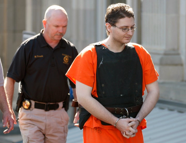 This April 23, 2012, photo shows Kevin Sweat being escorted from the courthouse in Okemah, Okla. Sweat is accused of killing two young girls in 2008 and is scheduled to be formally arraigned on June 5, 2012, on a first-degree murder count stemming from the July death of his girlfriend.