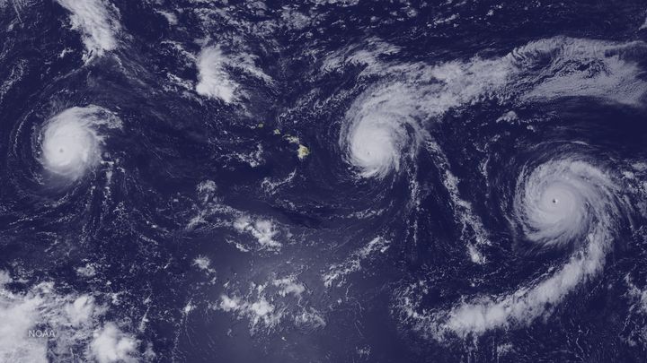 This satellite image taken Aug. 31 shows Hurricanes Kilo (left), Ignacio (center) and Jimena (right) surrounding the Hawaiian Islands.