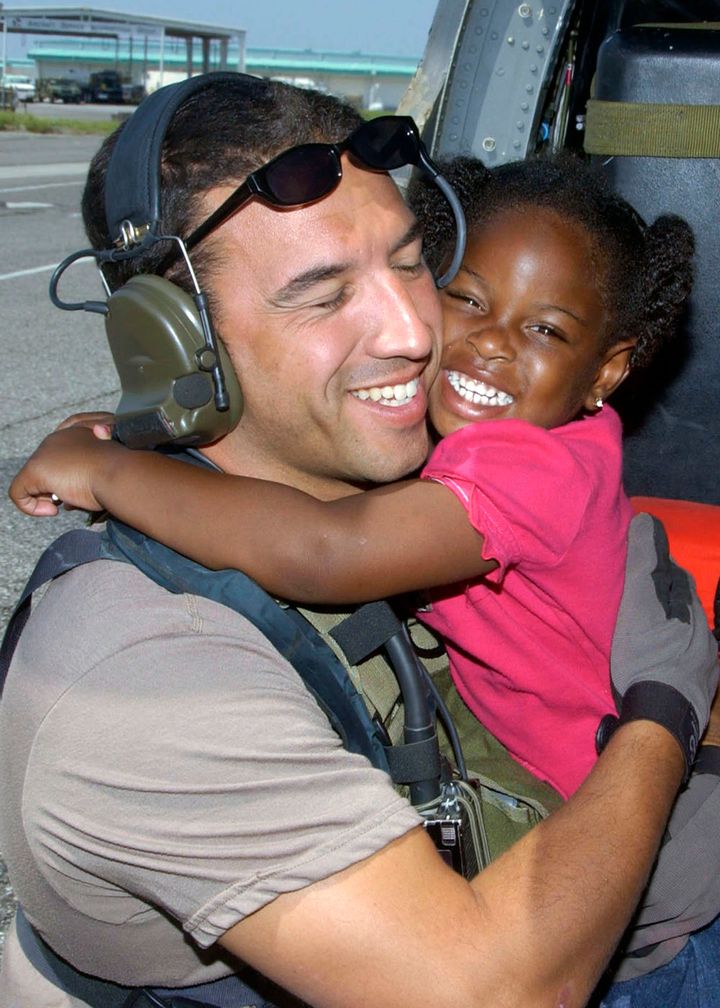 Maroney and then-3-year-old LeShay Brown in the iconic photo taken after the girl and her family were rescued. 