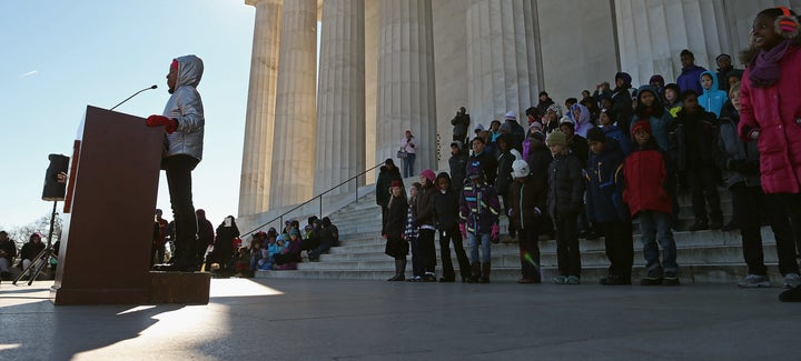 Fifth-graders from Watkins Elementary School in the District of Columbia take turns reciting excerpts of the "I Have a Dream" speech to commemorate Martin Luther King Jr.'s birthday on the steps of the Lincoln Memorial, Jan. 18, 2013.