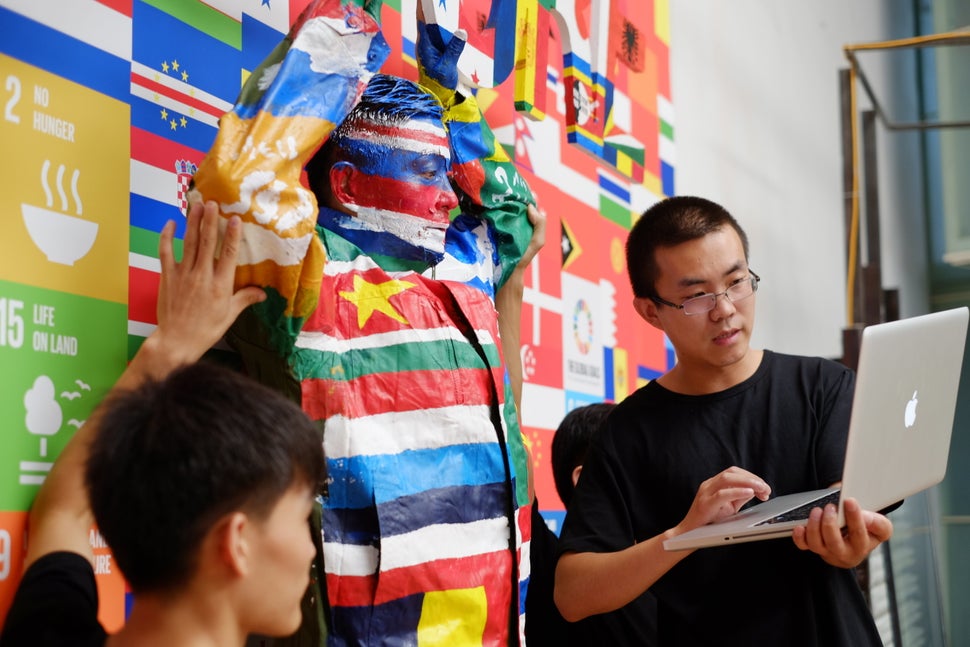 Liu periodically checks the work's progress by viewing pictures on his laptop and making minute tweaks as needed.