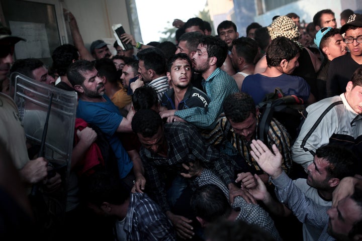 People scuffle as they wait to be registered by the police in the port of Mytilene on Lesbos, Greece, on Sept. 3, 2015.