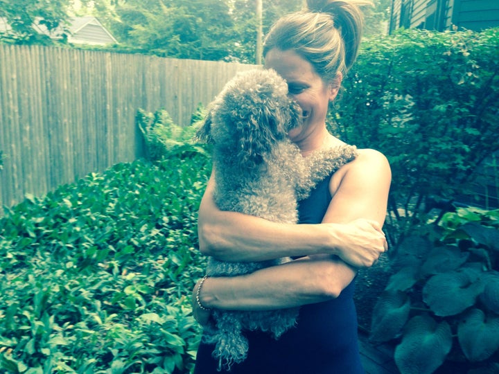 <p>Susan and her pup Violet in the backyard of her "empty-nester dream home."</p>