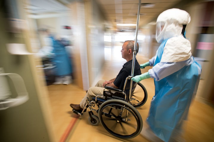 University of Minnesota Medical Center nurses wheel a volunteer through the hospital, recreating the path a potential Ebola patient would take through the facility to its isolation ward. 