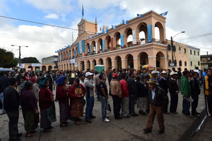 People queue at polling stations in San Juan Sacatepequez, 40 km west of Guatemala City, during general elections on September 6, 2015. 