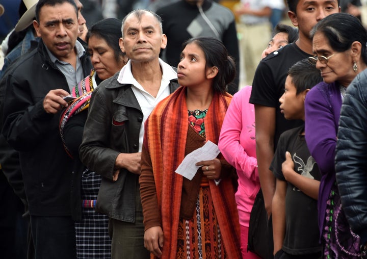 People queue at a polling station in San Juan Sacatepequez, 40 km west of Guatemala City, during general elections on Septemb