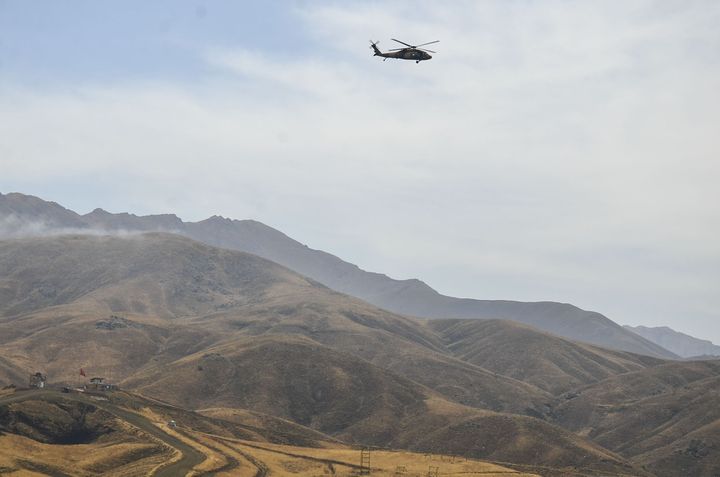 A Turkish military helicopter flies over Yuksekova district of Hakkari after a mine attack perpetrated by PKK militants in southeastern Turkey on Sept. 7, 2015
