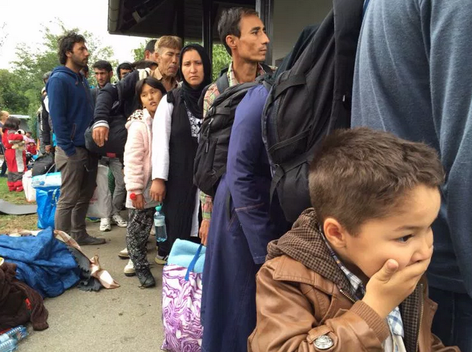 Syrian boy lines up with family to board a train near the Austrian border.
