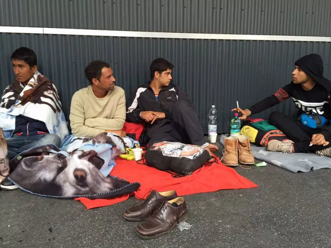 Syrian men rest in Austria.
