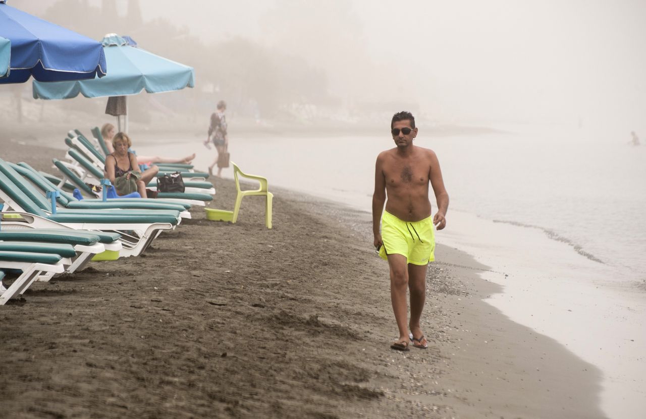 <p> A man walks on the beach in Limassol as a sandstorm hits the east Mediterranean island of Cyprus on Sept. 8, 2015.</p>