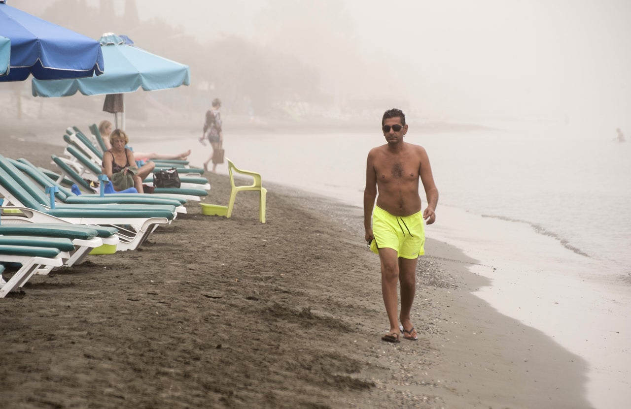  A man walks on the beach in Limassol as a sandstorm hits the east Mediterranean island of Cyprus on Sept. 8, 2015.