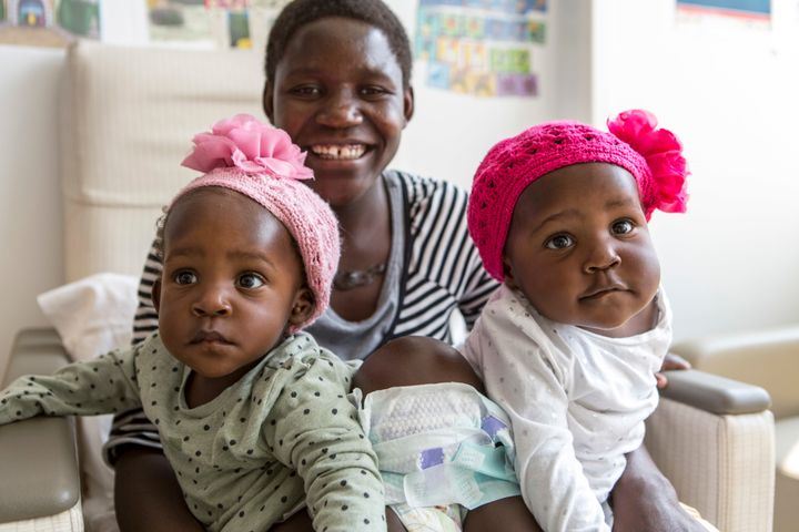 Acen (left) and Apio (right) Akello are pictured here in their hospital room with their mother, Ester.