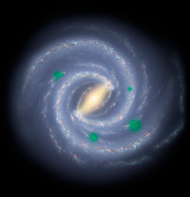 In this artist's rendition of the Milky Way galaxy, translucent green "bubbles" mark areas where life has spread beyond its home system to create cosmic oases, a process called panspermia. New research suggests that we could detect panspermia if it is indeed a real phenomenon.