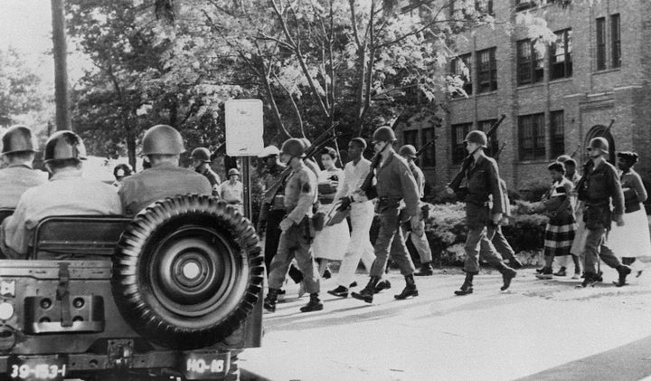 <p>Nine black high school students in Little Rock, Arkansas, are escorted by U.S. paratroopers on Sept. 25, 1957. Gov. Orval Faubus had earlier ordered the state militia to bar the teens' entry to Central High School.</p>