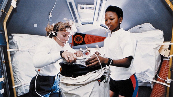 Mission specialist N. Jan Davis works with Mae Jemison while in orbit.