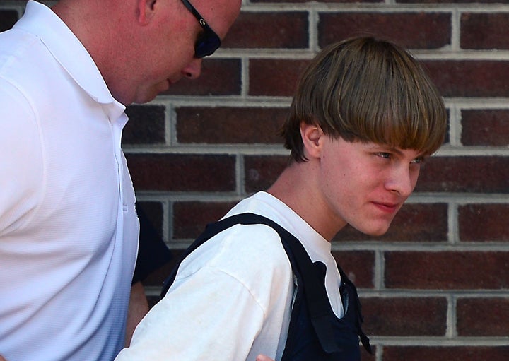 <p>Charleston shooting suspect Dylann Roof is escorted from the police department on June 18, 2015, in Shelby, South Carolina.</p>