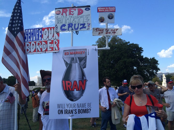 Tracey Anderson from Indianapolis stands to the right of signs opposing the Iran deal.