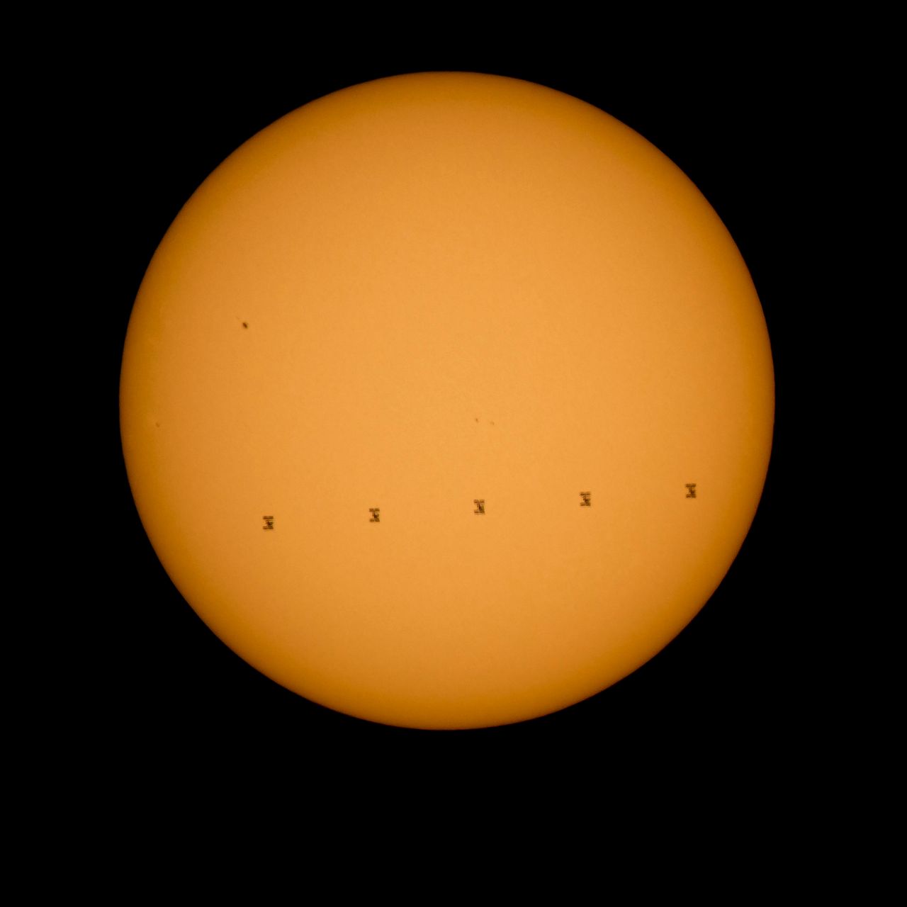 This NASA image shows the International Space Station silhouetted against the sun. 