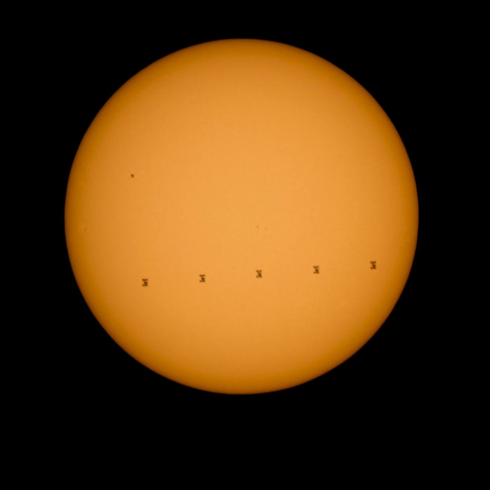 <span>This NASA image shows the International Space Station silhouetted against the sun. </span>