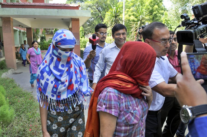 Two women return to Nepal after alleged abuse at the hands of their employer.