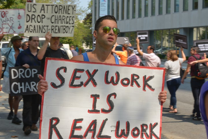 A demonstrator protests the federal raid on Rentboy.com, a male escort site.