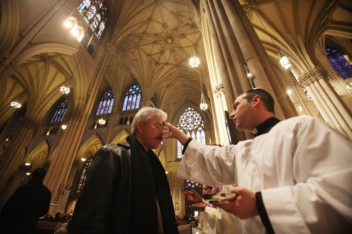 Seminarian Richard Marrano (R) distributes ahes to a worshiper during Ash Wednesday services at Saint Patrick's Cathedral on March 9, 2011 in New York City. 