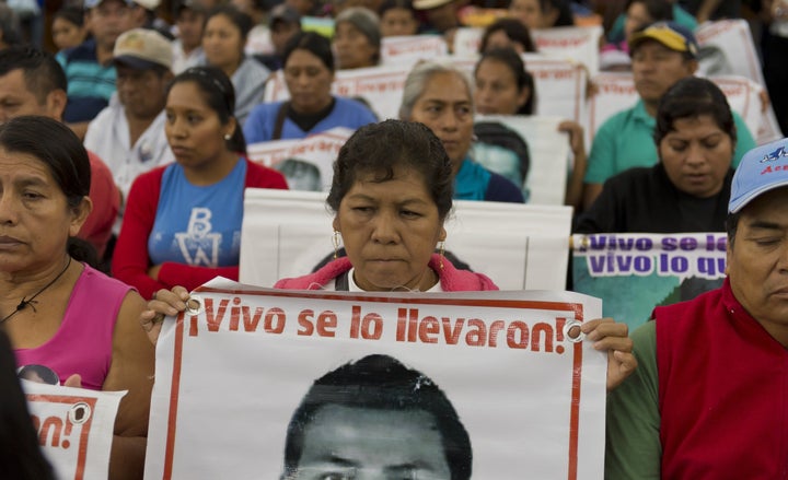 <p>Relatives and friends of the 43 missing Ayotzinapa students wait before the IACHR present the first conclusions of their investigation in Mexico City on Sept. 6, 2015.</p>