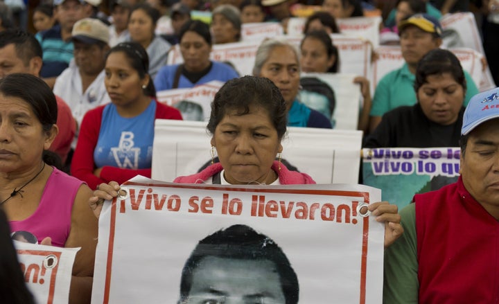 Relatives and friends of the 43 missing Ayotzinapa students wait before the IACHR present the first conclusions of their investigation in Mexico City on Sept. 6, 2015.