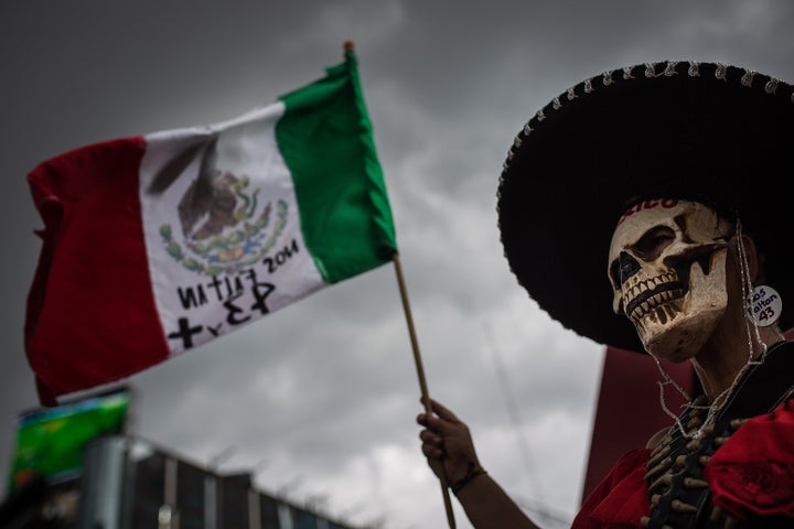 <p>A protester marks 11 months since the disappearance of the 43 Ayotzinapa students in Mexico City, Aug. 26, 2015.</p>