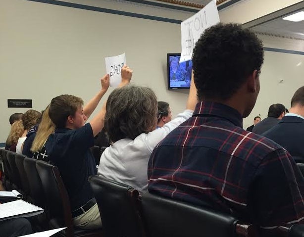 <p>Stanford students hold up signs to voice their objections at a hearing on the Safe Campus Act, which they say will prevent students from reporting sexual assaults.</p>