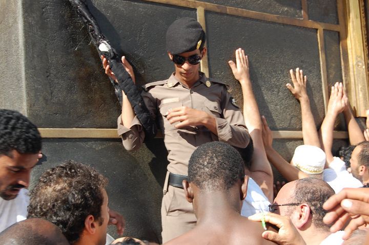 <p>A Saudi policeman guards the entrance to the Kaaba. For millions of pilgrims just touching the Kaaba brings absolution. But for many pilgrims, strategically placed guards like this one are a constant reminder of the Saudi control over their pilgrimage. </p>