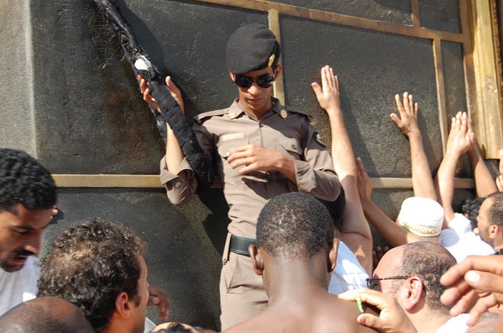 A Saudi policeman guards the entrance to the Kaaba. For millions of pilgrims just touching the Kaaba brings absolution. But for many pilgrims, strategically placed guards like this one are a constant reminder of the Saudi control over their pilgrimage. 