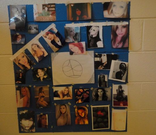 Pictures of James Holmes' admirers cover the wall of his jail cell.