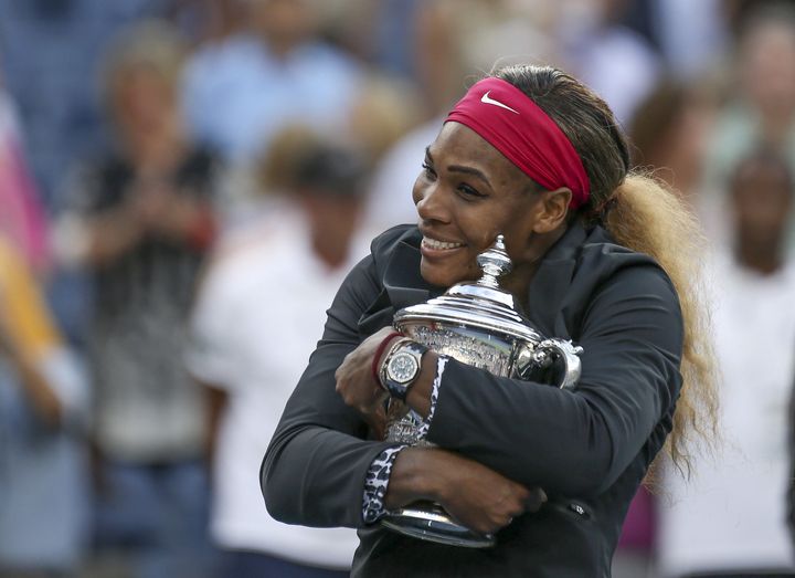 Serena Williams hugs her 2014 U.S. Open trophy. 