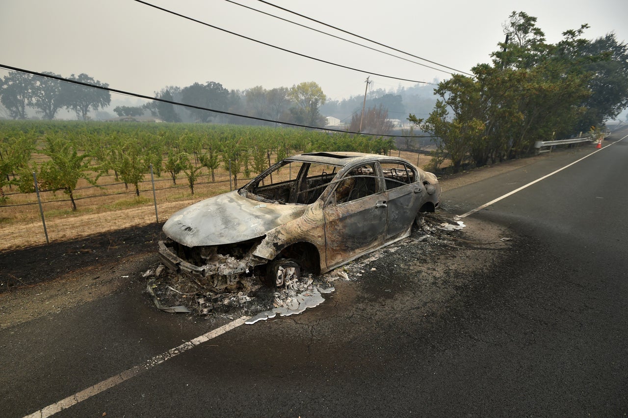 Melted metal flows from a burned out car abandoned on a highway in Middletown, California, Sept. 13, 2015. 