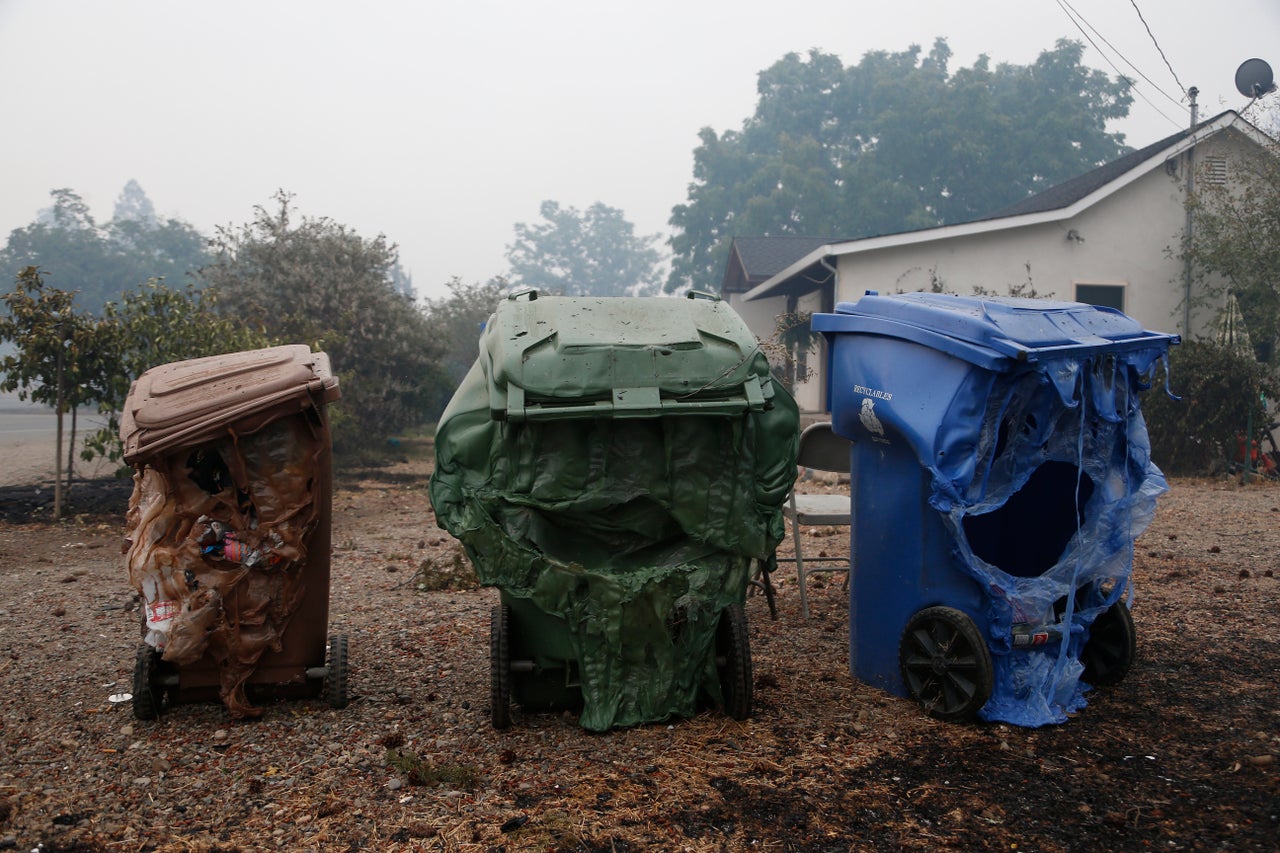 Melted garbage containers damaged by the wildfire sit near homes in Middletown, California, Sept. 13, 2015.