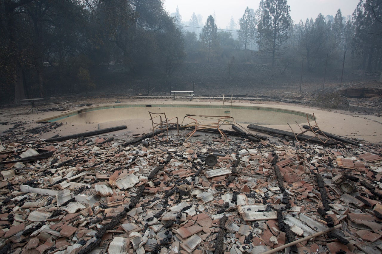 Structures around a pool lie in ruins after the wildfire destroyed the Golden Spur mini market north of Murphys, near San Andreas, Sept. 13, 2015. 