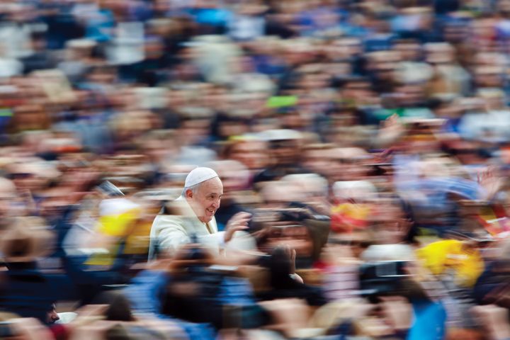A swirl of pilgrims surround Pope Francis in St. Peter’s Square.