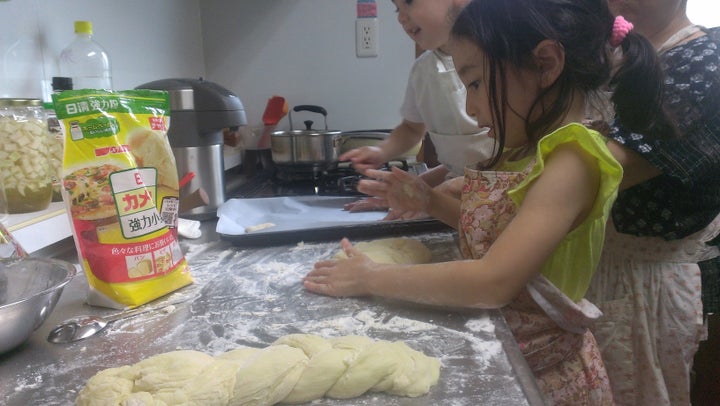 Melissa Uchiyama's children braid challah bread with their grandmother in Tokyo.