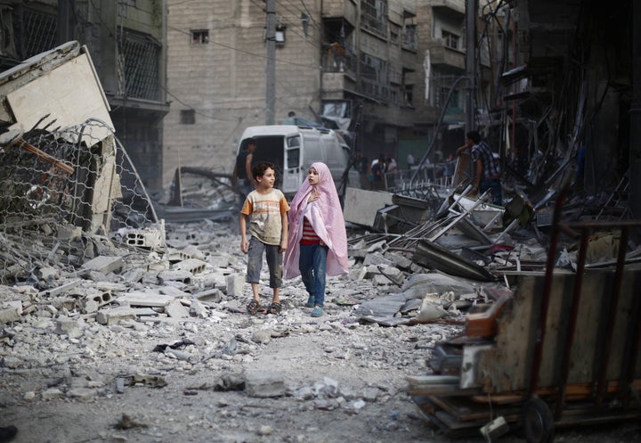 People are seen after Assad regime forces' air-strike staged to residential areas, in Douma District of East Ghouta region of Damascus, Syria on September 11, 2015.