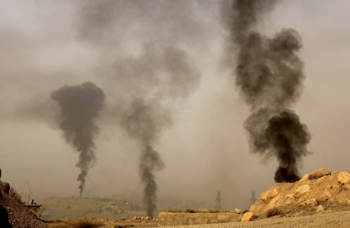 Smoke rises as Syrian opposition members fight against Assad Regime Forces in Tall Kurdi village, Damascus, Syria on September 12, 2015.