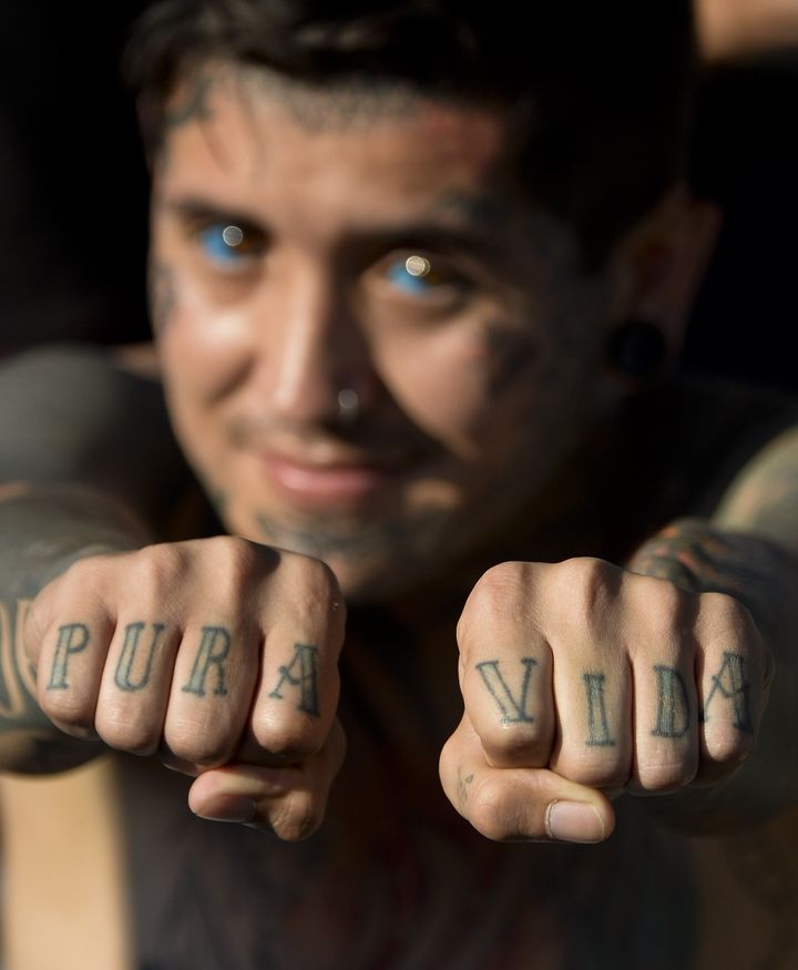 Body modification artist Damian Carnicero shows off his finger tattoos that mean "Pure Life" at the 2015 Cali Tattoo Festival in Cali, Colombia.