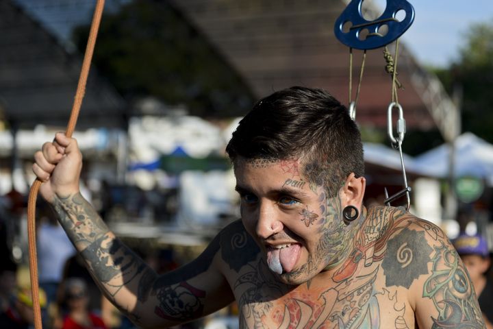 Body modification artist Damian Carnicero suspends himself with metal hooks attached to his back at the 2015 Cali Tattoo Festival in Cali, Colombia.