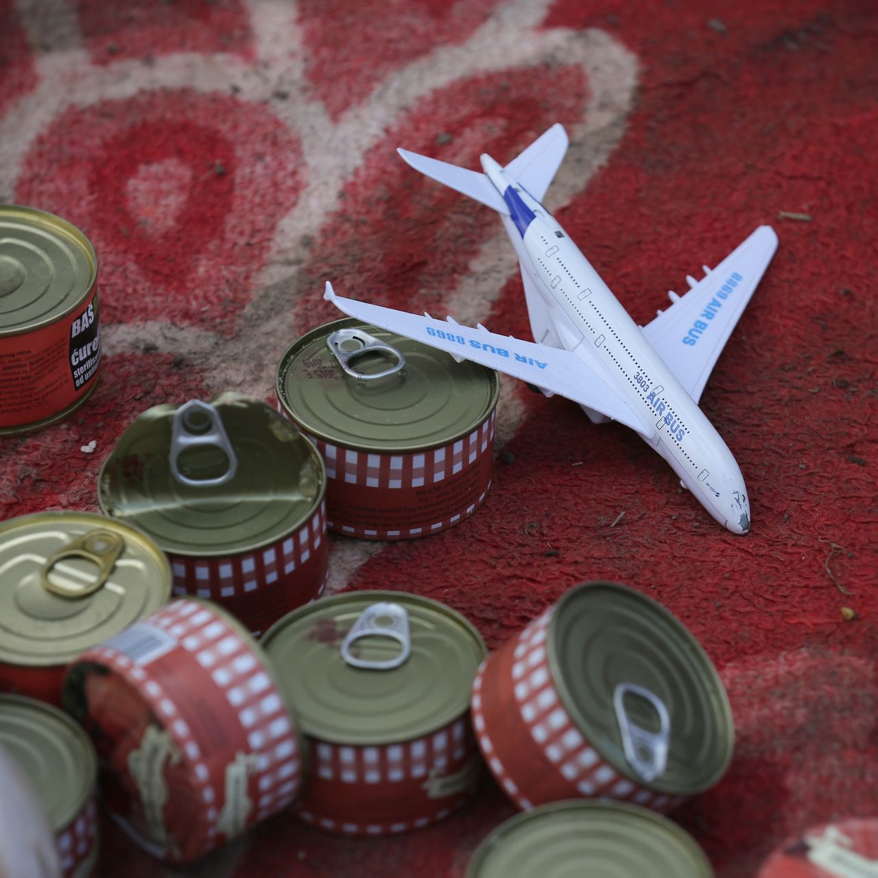 A toy aircraft and cans of food.