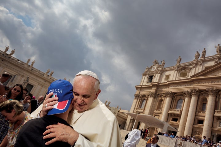 Pope Francis embraces a member of his flock during a Wednesday morning general audience. Tens of thousands of people, the faithful and the curious, attend these events.